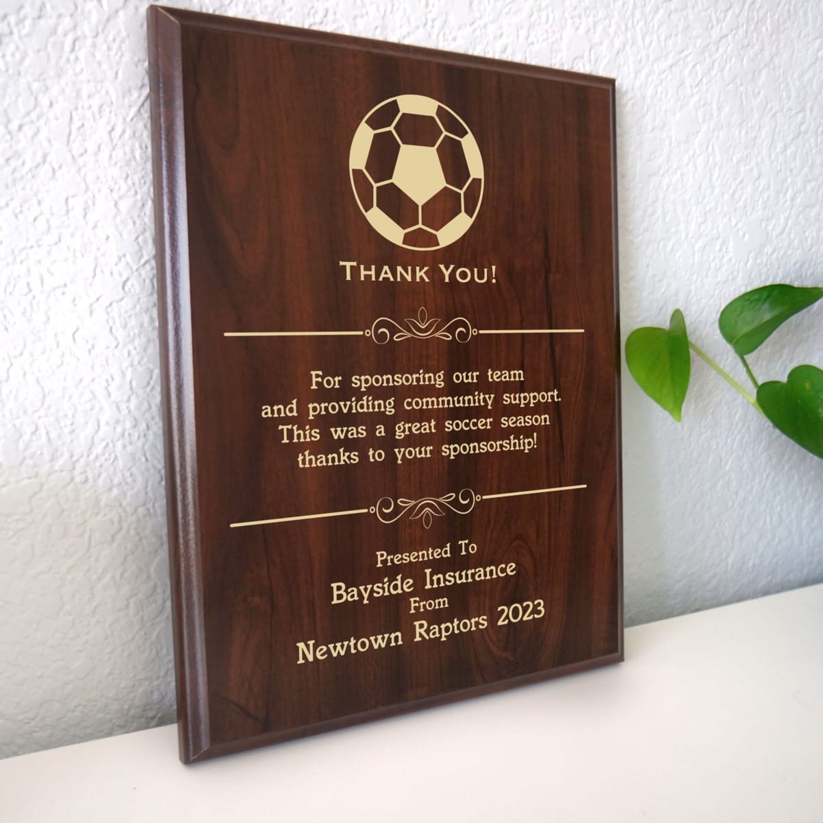 Photo of plaque resting on table at an angle.